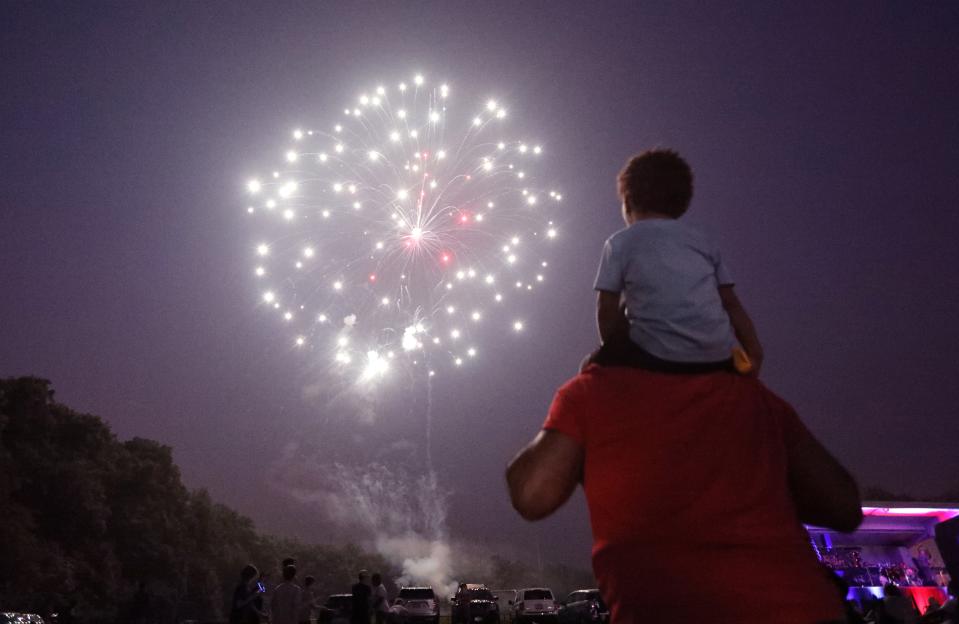 Gregory Pereira of New City and his great-grandson Hector Gonzalez watch the Town of Clarkstown's fireworks show at Felix Festa Middle School in West Nyack June 29, 2023.