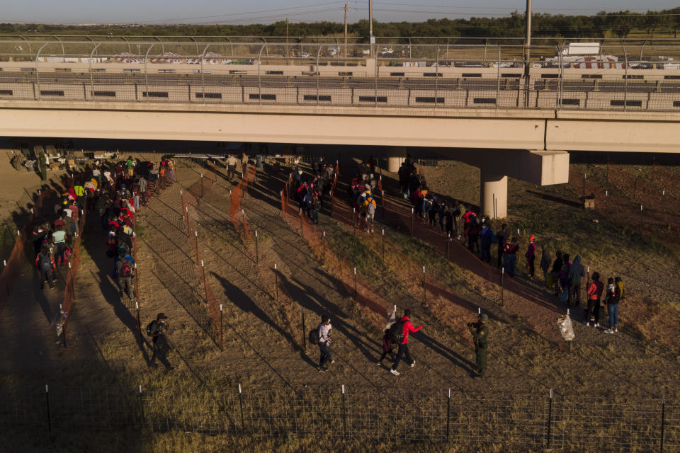 Migrants, many from Haiti, are seen in lines waiting to board busses at an encampment along the Del Rio International Bridge near the Rio Grande, Thursday, Sept. 23, 2021, in Del Rio, Texas. (AP Photo/Julio Cortez)