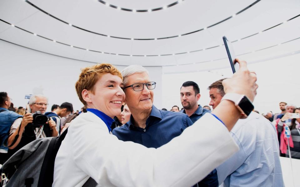 Apple chief executive Tim Cook (right) confirmed the release of iOS 14 in an online presentation on Tuesday - AFP