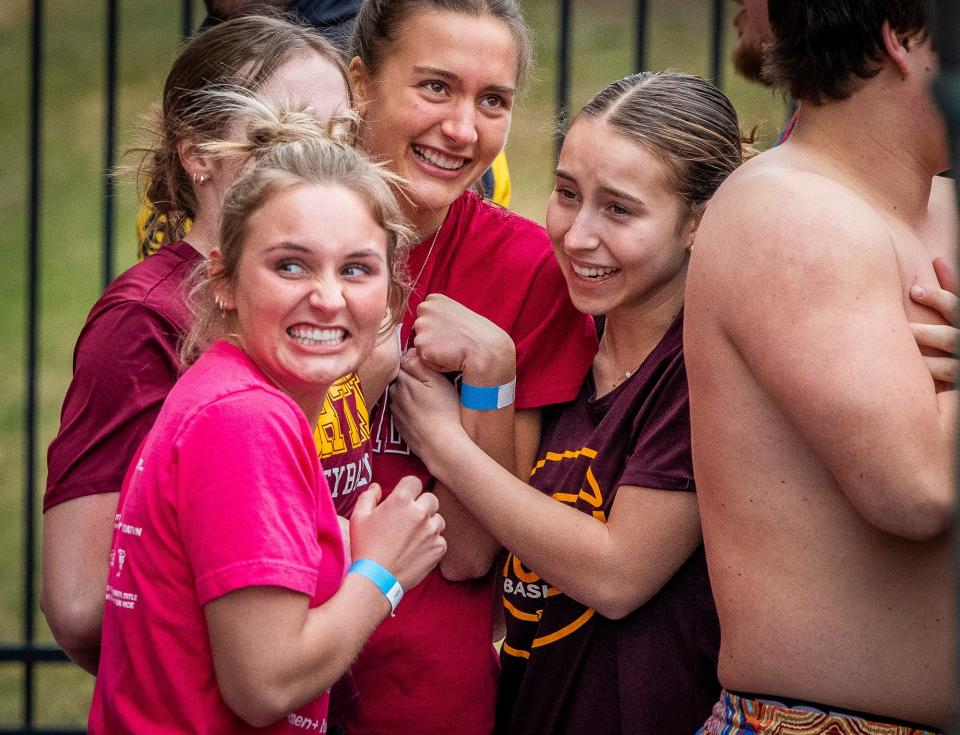 Bloomington North students Reese Pendill, front in pink, Claire Hodson, left, Morgan Barrow, middle, and Ava Robbennolt, right, nervously anticipate their jump into the cold water at the 2024 Polar Plunge benefitting Special Olympics Indiana at Memorial Stadium on Saturday, Feb. 24, 2024.