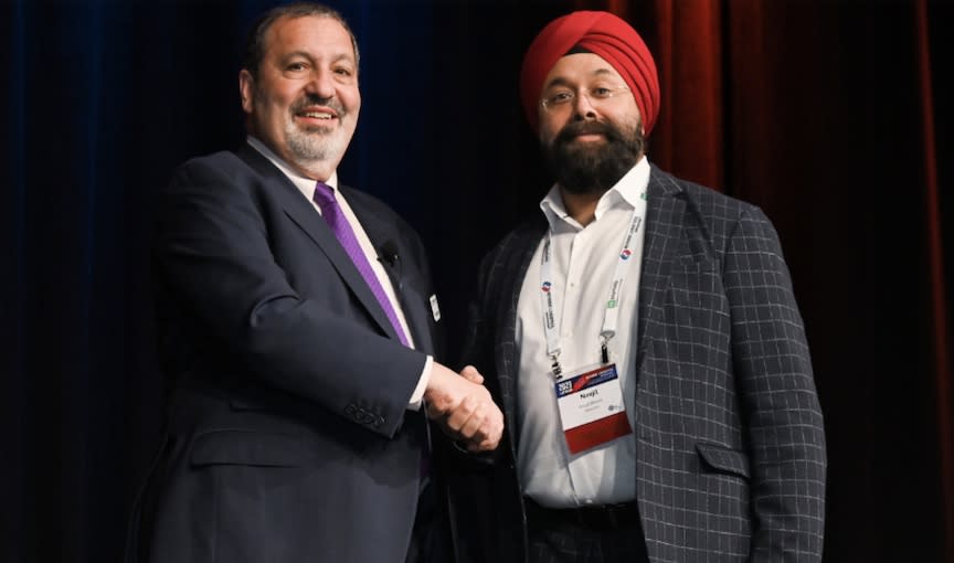 Newmine Founder and CEO Navjit Bhasin is congratulated after Newmine took the top prize in a startup competition by the Reverse Logistics Association in February in Las Vegas.