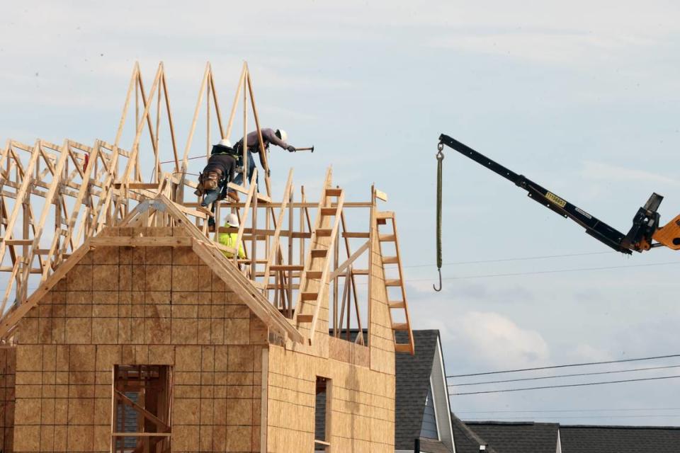 A construction crew builds a new house Monday in Fort Mill in the Elizabeth community. Home construction has been constant during the town’s growth surge that places it among the fastest growing cities and towns in the country.