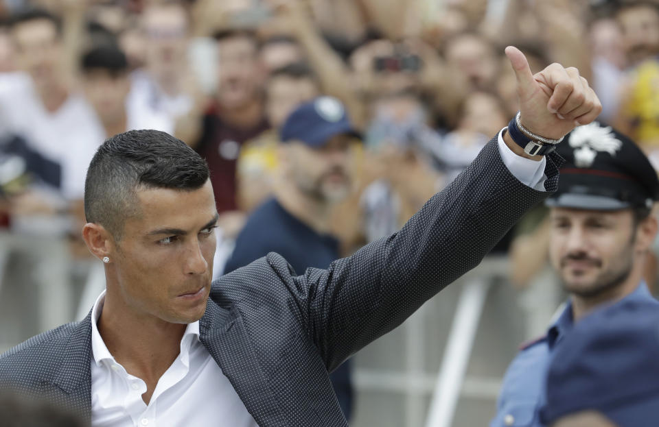 FILE - In this Monday, July 16, 2018 filer, Portuguese ace Ronaldo gives the thumb-up sign as he arrives to undergo medical checks at the Juventus stadium in Turin, Italy. Cristiano Ronaldo will likely make his Juventus debut at Chievo Verona as the Bianconeri kick off their attempt to win a record-extending eighth league title at the Stadio Bentegodi. The 2018-19 Serie A fixtures have been announced and the opening weekend also sees Napoli visit Lazio. The season starts on Aug. 18 and finishes May 26. (AP Photo/Luca Bruno, File)