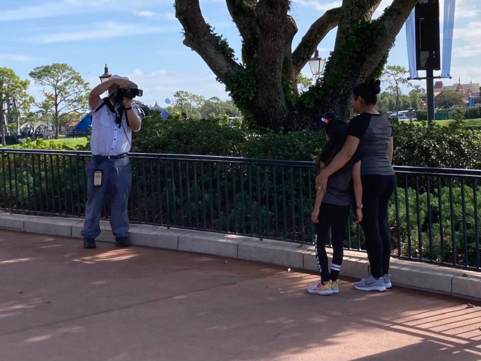 Disney photographers are stationed at prime spots all around the parks to snap photos of guests.