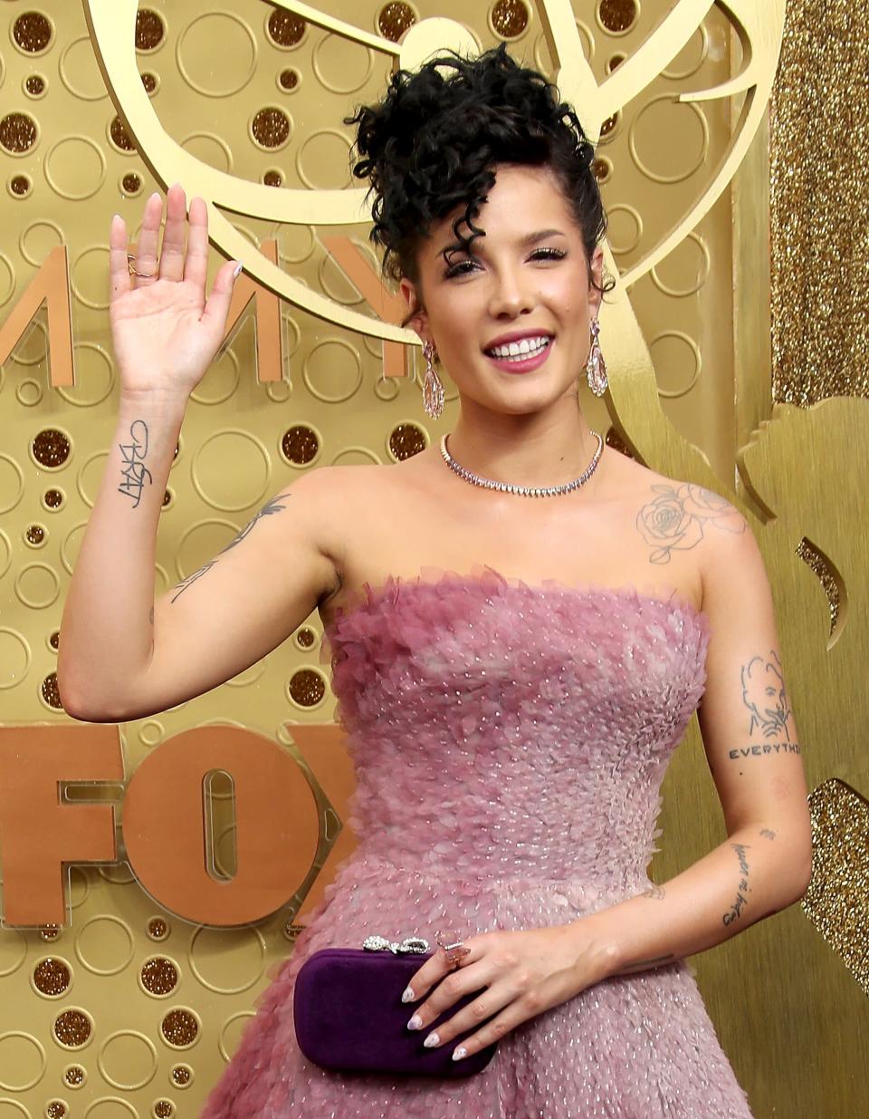 <p>The word "Brat" is written in cursive on Halsey's right arm. It's said to <a href="https://www.cosmopolitan.com/entertainment/celebs/g28869337/halsey-tattoos-meaning/?slide=10" class="link " rel="nofollow noopener" target="_blank" data-ylk="slk:refer to her teenage years">refer to her teenage years</a> and the nickname her parents gave her.</p>