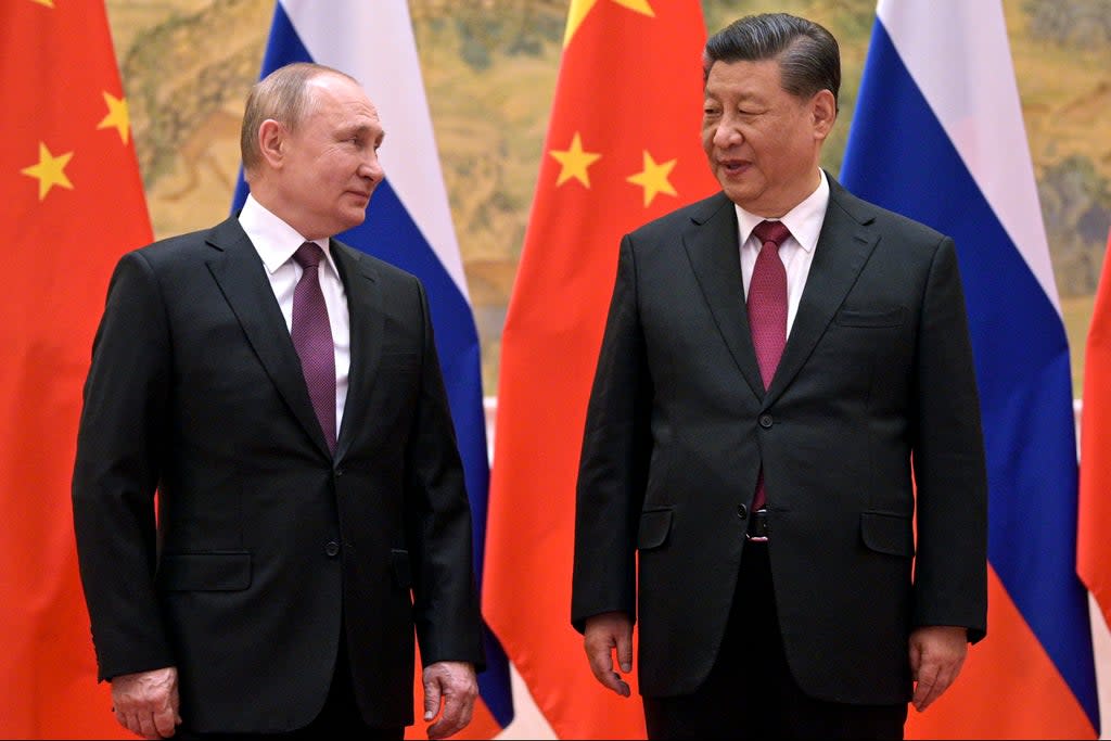 Chinese President Xi Jinping, right, and Russian President Vladimir Putin talk to each other during their meeting in Beijing, Feb. 4, 2022.  (AP)