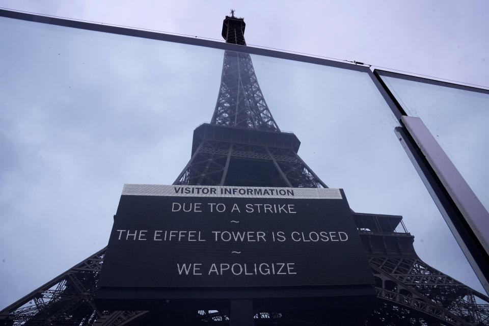 A board advertises a strike at the Eiffel Tower Monday, Feb. 19, 2024 in Paris. Visits to the Eiffel Tower were disrupted on Monday Feb. 19, 2024 because of a strike over poor financial management of the monument, which is one of the world's most-visited sites. (AP Photo/Michel Euler)