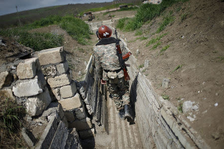 Ethnic Armenian soldiers walk in a trench at their position near Nagorno-Karabakh's boundary, April 8, 2016. REUTERS/Staff/File Photo