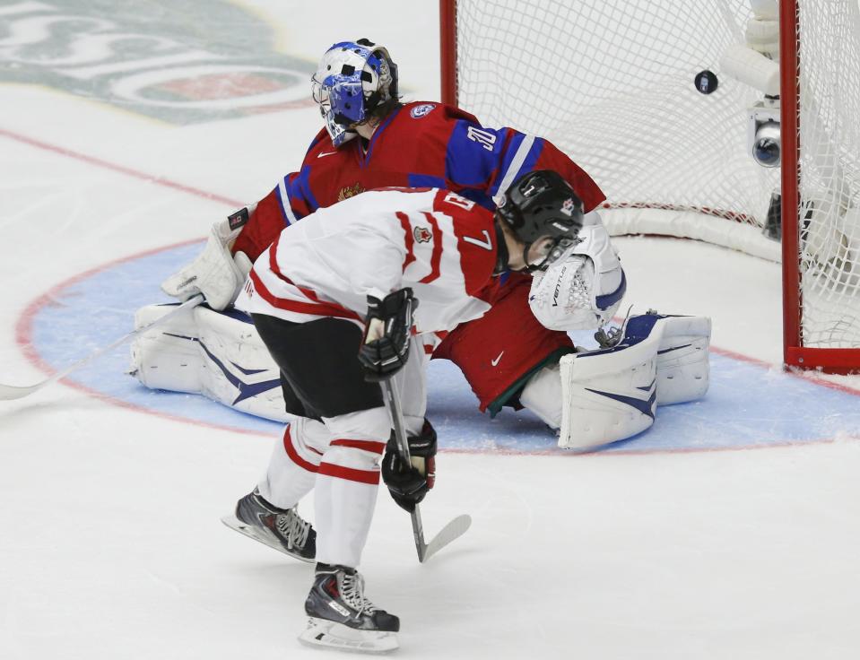 Canada's Josh Morrissey scores on Russia's goalie Andrei Vasilevski during the third period of their IIHF World Junior Championship ice hockey game in Malmo, Sweden, January 5, 2014. REUTERS/Alexander Demianchuk (SWEDEN - Tags: SPORT ICE HOCKEY)