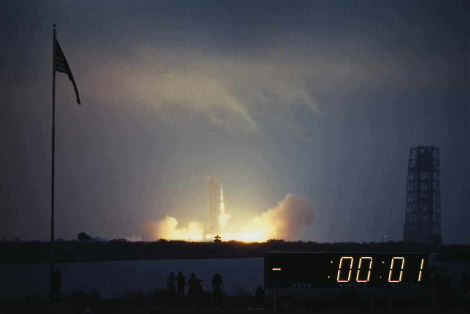 (Original Caption) Apollo 12 ingition and blast-off as viewed from a distance. The countdown clock in the foreground measures the seconds until blast time. Apollo 12 astronauts are Charles Conrad, Alan Bean and Richard Gordon.