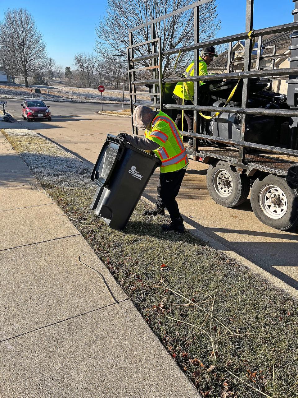 A Columbia Solid Waste worker delivers a roll cart January 30 to a city residence. Department leadership have addressed first-day automated trash pick-up hiccups.