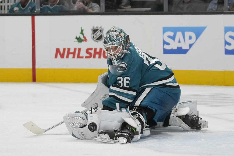 San Jose Sharks goaltender Kaapo Kahkonen deflects a shot attempt by the Vancouver Canucks during the second period of an NHL hockey game in San Jose, Calif., Saturday, Nov. 25, 2023. (AP Photo/Jeff Chiu)