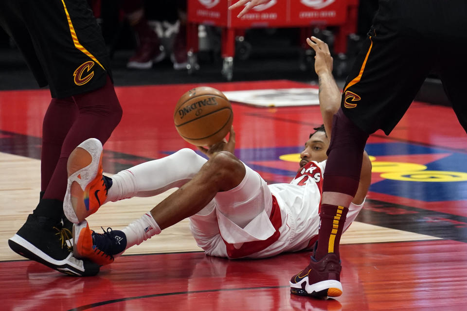 Toronto Raptors center Khem Birch (24) makes a pass as he falls down during the second half of an NBA basketball game against the Cleveland Cavaliers Monday, April 26, 2021, in Tampa, Fla. (AP Photo/Chris O'Meara)