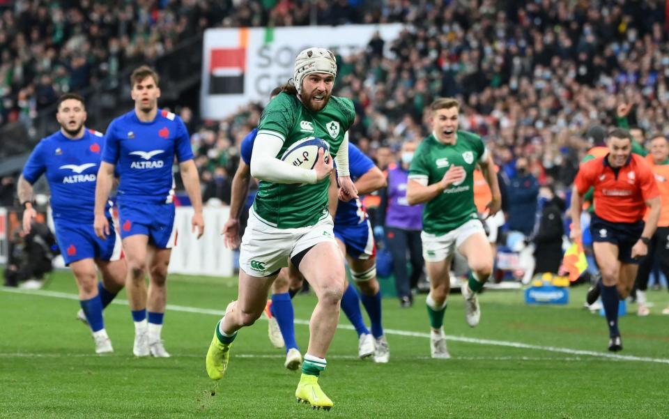 Ireland's wing Mack Hansen runs to score a try during the Six Nations rugby union international match between France and Ireland at the Stade de France, in Saint-Denis - GETTY IMAGES