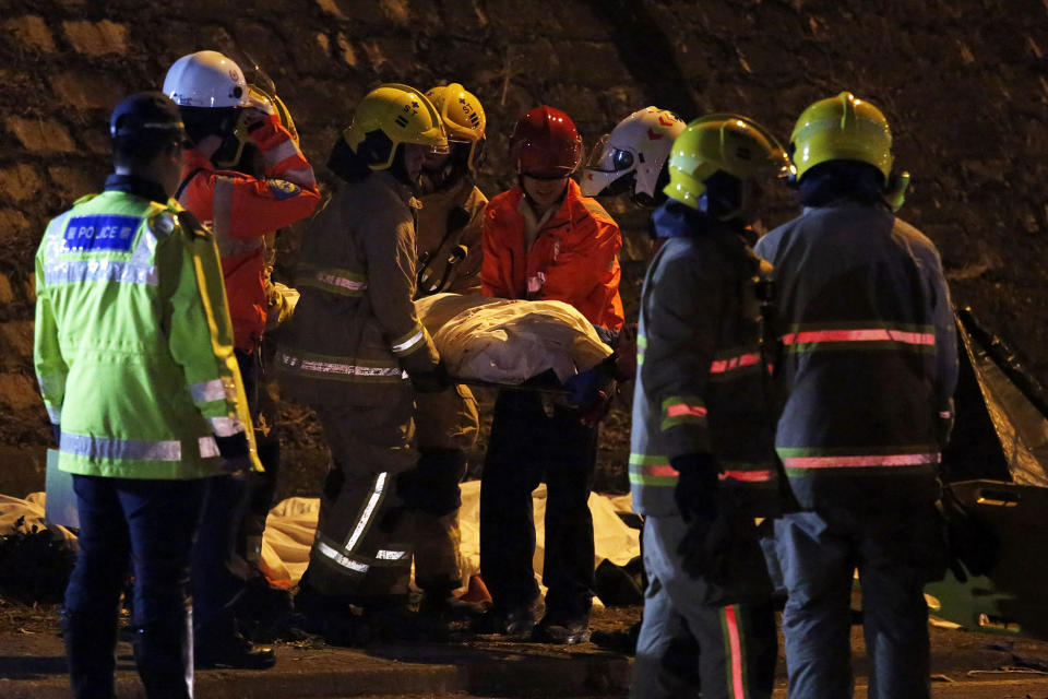 <p>Rescuers carry a body after a bus crashed in Hong Kong, China, Feb. 10, 2018. (Photo: Bobby Yip/Reuters) </p>