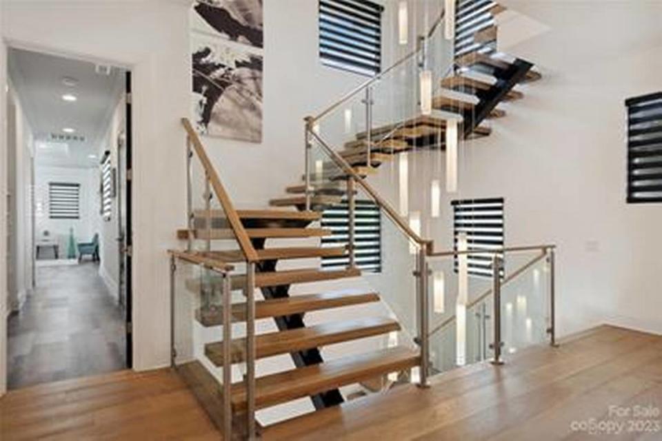 The focal point of the mansion is a 36-foot tall, free-floating staircase made of wood, metal and glass .