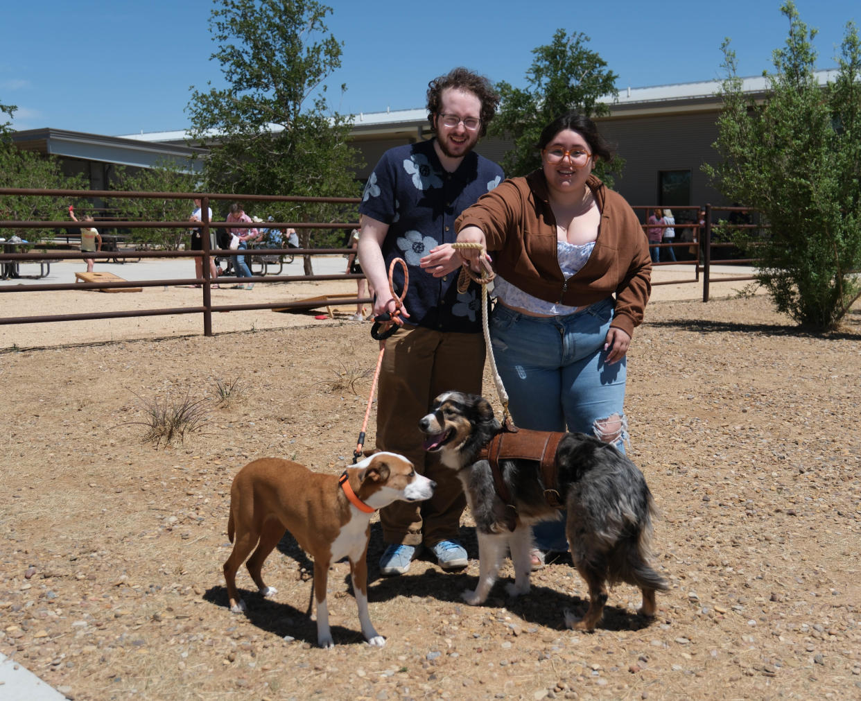 A couple with their dogs Sky and Jasper enjoy the day at the Texas Tech School of Veterinary Medicine "Barks and Recreation" event Saturday at Mariposa Station in west Amarillo.
