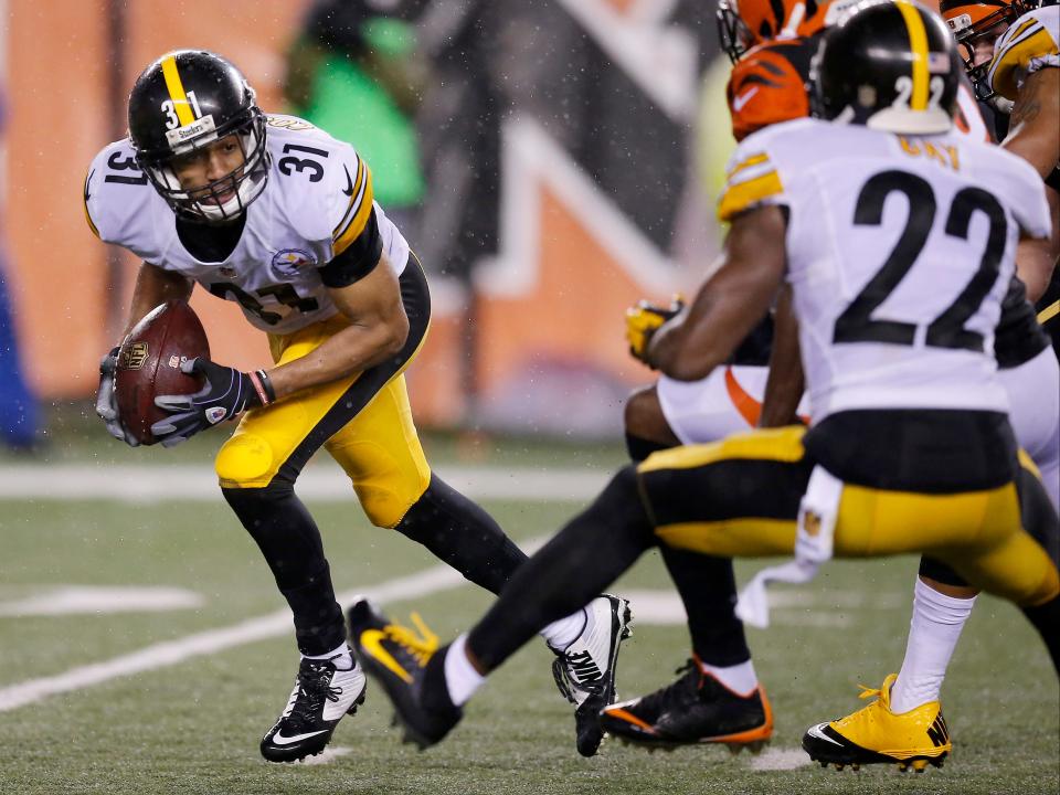 Pittsburgh Steelers defensive back Ross Cockrell (31) recovers a fumble by Cincinnati Bengals running back Jeremy Hill (32) in the fourth quarter of the NFL AFC wild-card playoff game between the Cincinnati Bengals and the Pittsburgh Steelers at Paul Brown Stadium in downtown Cincinnati on Saturday, Jan. 9, 2016. The Steelers defeated the Bengals, 18-16, on a field goal drive in the final minutes of the game.