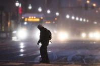 <p>A man crosses Market Street during a winter storm in Philadelphia, Thursday, Feb. 9, 2017. A powerful, fast-moving storm swept through the northeastern U.S. Thursday, making for a slippery morning commute and leaving some residents bracing for blizzard conditions. (Photo: Matt Rourke/AP) </p>