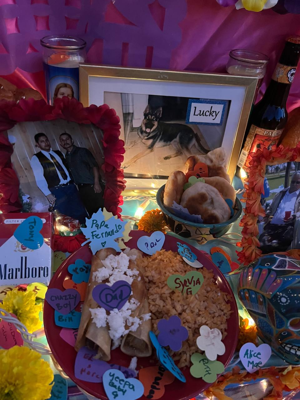 Pictures of dead pets and family members are displayed alongside candles and "ofrendas," or offerings, on an altar during the Día de Los Muertos celebration at the Hollywood Forever Cemetery in Los Angeles on Saturday, Oct. 28, 2023.