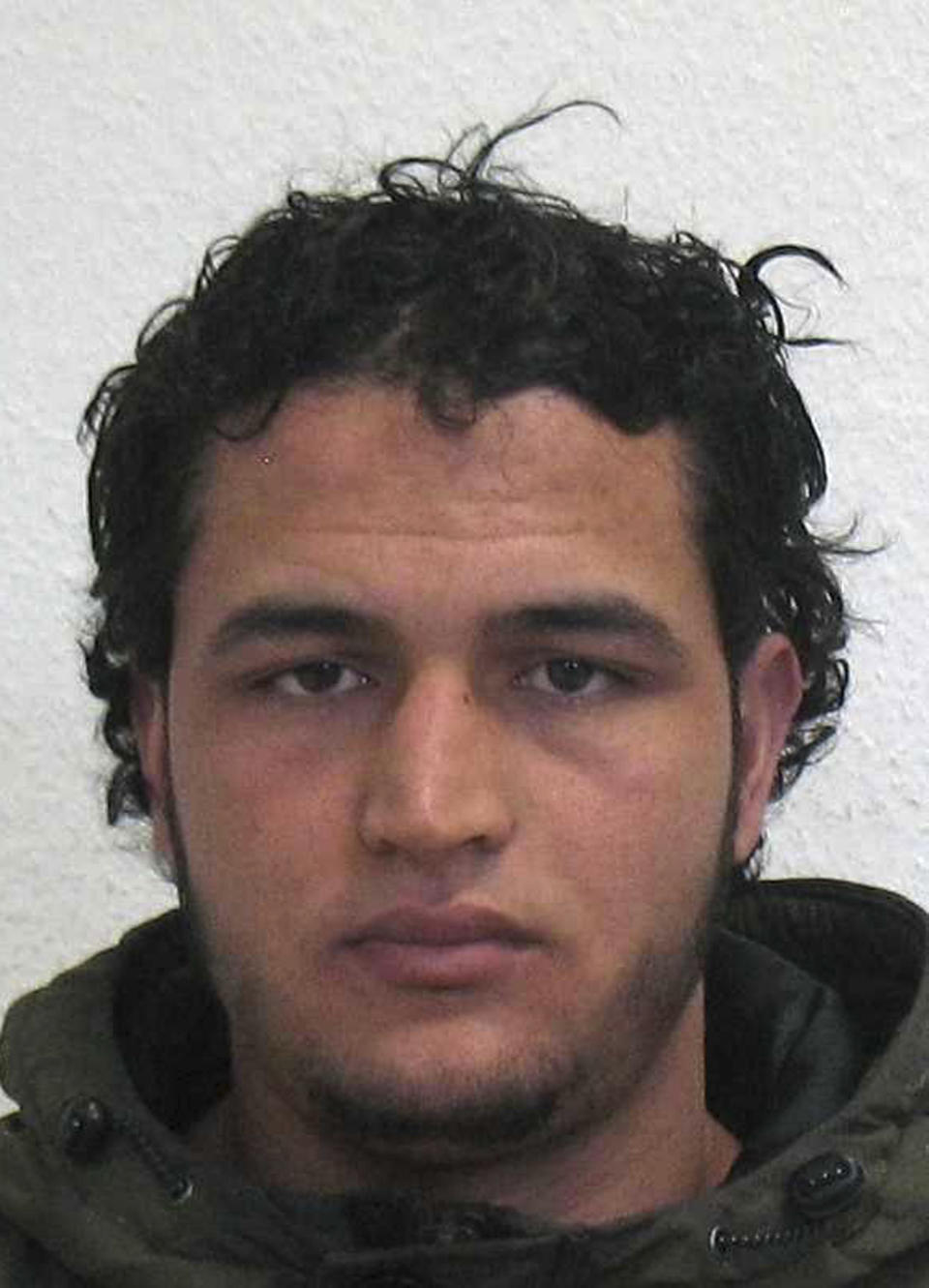 The wanted photo issued by German federal police on Wednesday, Dec. 21, 2016 shows 24-year-old Tunisian Anis Amri who is suspected of being involved in the fatal attack on the Christmas market in Berlin on Dec. 19, 2016. The Tunisian man suspected of driving a truck into a crowded Christmas market in Berlin was killed early Friday Dec. 23, 2016 in a shootout with police in Milan, ending a Europe-wide manhunt, Italy's interior minister said.(German police via AP)