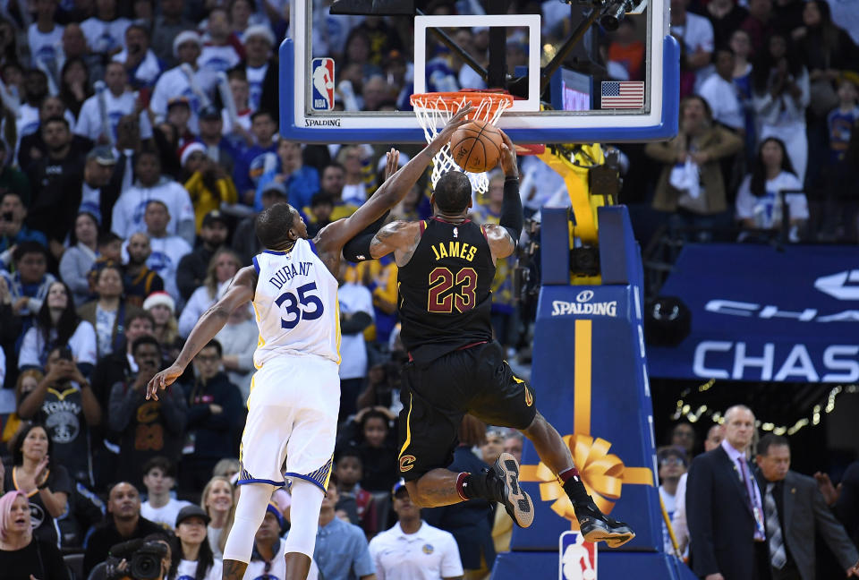 Kevin Durant, challenging LeBron James at the rim, has committed to turning himself into a defensive titan. (Getty)