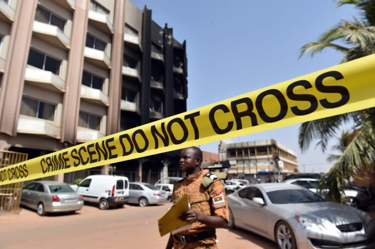 A soldier stands behind a security barrier ouside the damaged Splendid Hotel in Burkina Faso's capital Ouagadougou on January 17, 2016