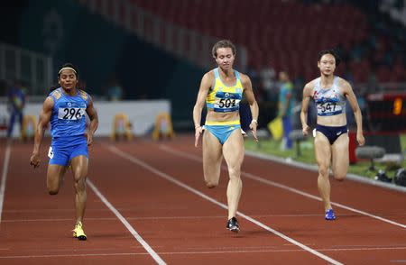 Athletics - 2018 Asian Games - Women's 100m Semi-final - GBK Main Stadium – Jakarta, Indonesia – August 26, 2018 – Dutee Chand of India, Olga Safronova of Kazakhstan and Kim Minji of South Korea compete. REUTERS/Darren Whiteside