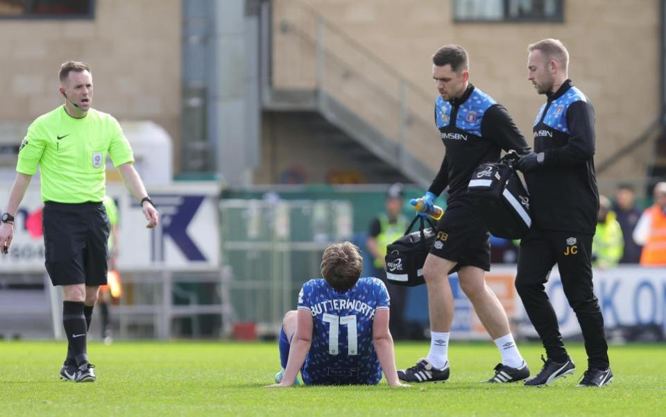 News and Star: Chris Brunskill and James Counsell attend to the injured Dan Butterworth at Northampton