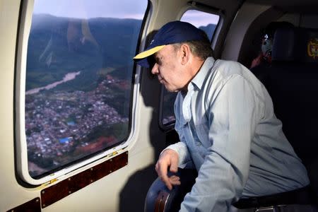 Colombia's President Juan Manuel Santos overflies a flooded area after heavy rains caused several rivers to overflow, pushing sediment and rocks into buildings and roads in Mocoa, Colombia April 1, 2017. Cesar Carrion/Colombian Presidency/Handout via Reuters