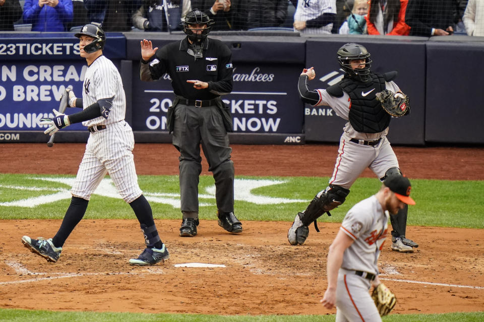 New York Yankees' Aaron Judge, left, reacts after striking out during the seventh inning of a baseball game against the Baltimore Orioles, Sunday, Oct. 2, 2022, in New York. (AP Photo/Frank Franklin II)