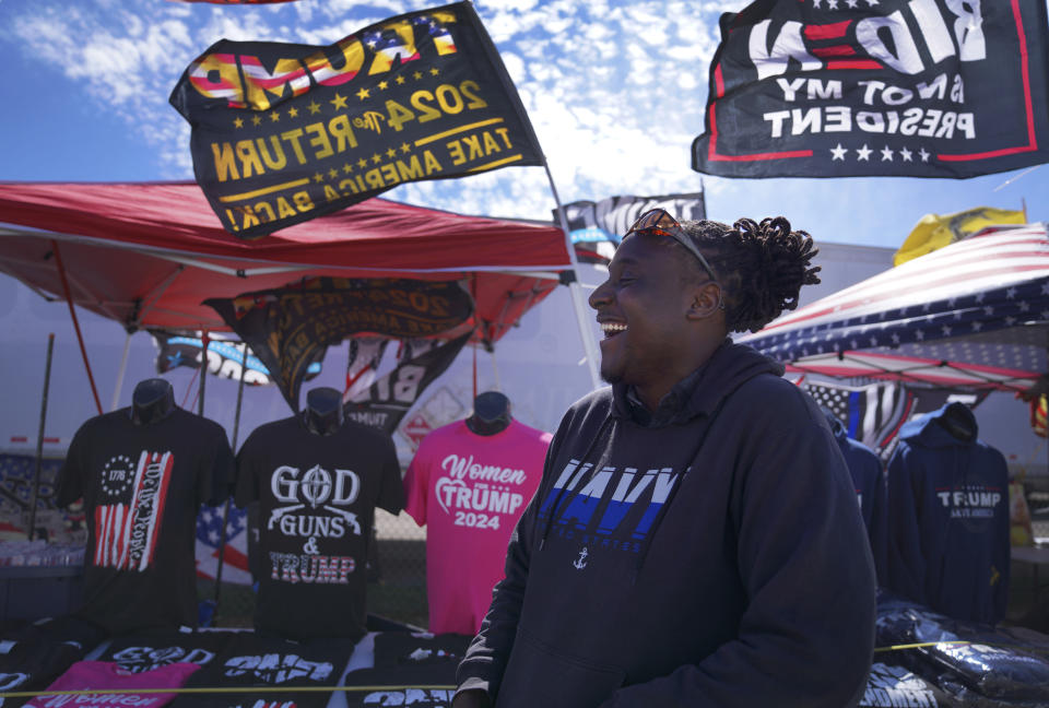 Thomas Isbell sells Donald Trump merchandise at a campaign rally for the former president, in Vandalia, Ohio, on Saturday, March 16, 2024. (AP Photo/Jessie Wardarski)