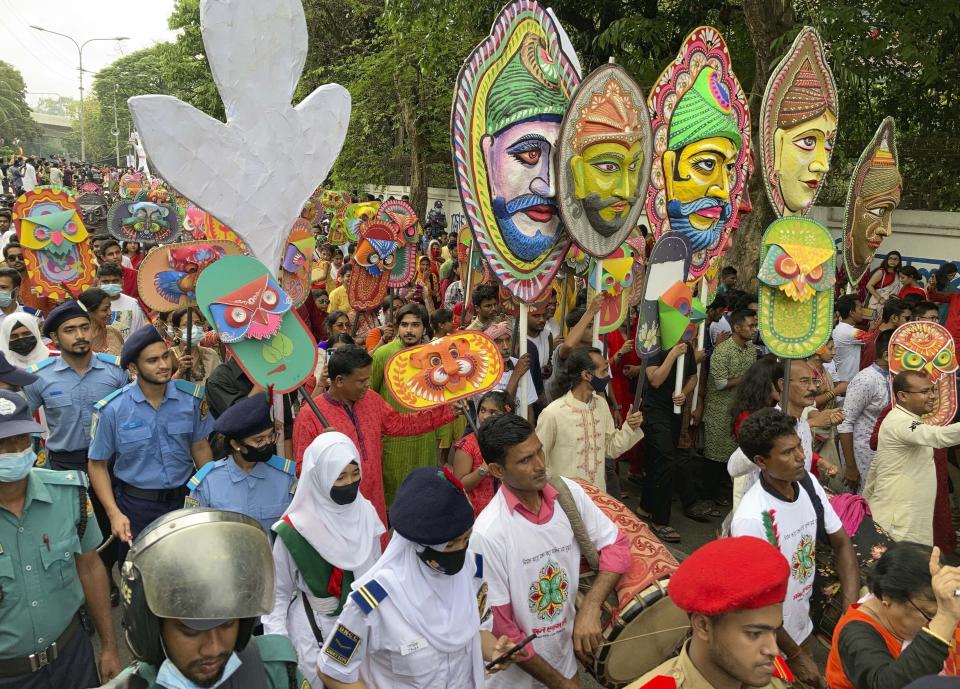 People walk in a procession to mark the Bengali New Year in Dhaka, Bangladesh, Wednesday, April 14, 2022. After a two-year break, thousands of people in Bangladesh and Nepal on Thursday celebrated their respective new years with colorful processions and musical soirees as the coronavirus pandemic eased and life swung back to normal. (AP Photo/Al Emrun Garjon)