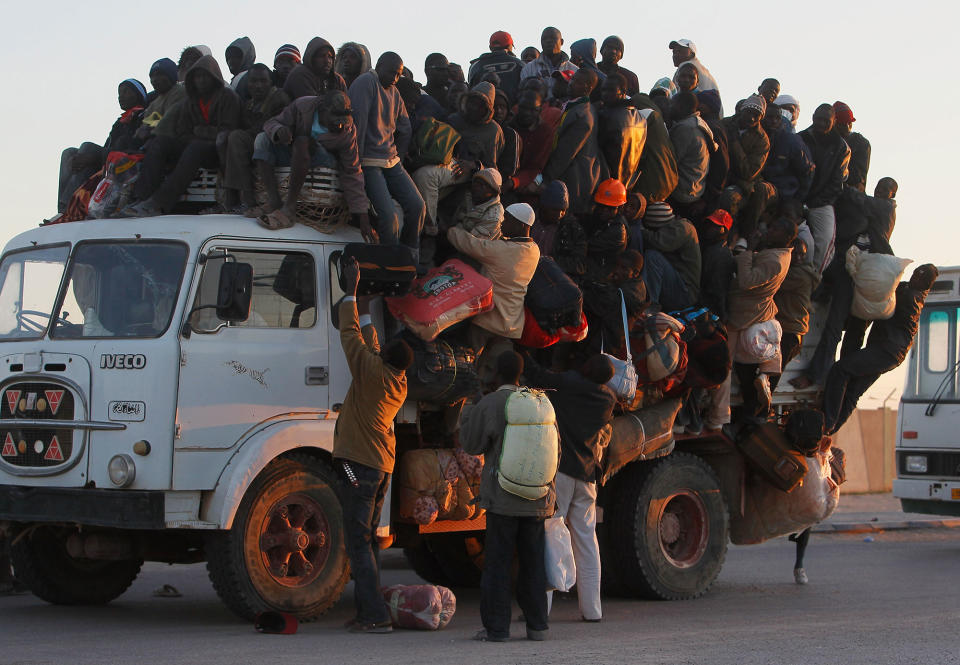 <p>Foreign workers from Nigeria, Ghana, and other African countries pile in the back of a truck with their belongings trying to leave the besieged city of Misrata April 18, 2011 as the sun sets on the port in Misrata, Libya. Thousands of foreign workers and Libyans alike are trying to leave war-torn Misrata, as fighting continued between Libyan government forces and anti-government rebels. The Libyan government has come under international criticism for using heavy weapons and artillery in its assault on Misrata, which can cause civilian casualties. (Photo by Chris Hondros/Getty Images) </p>