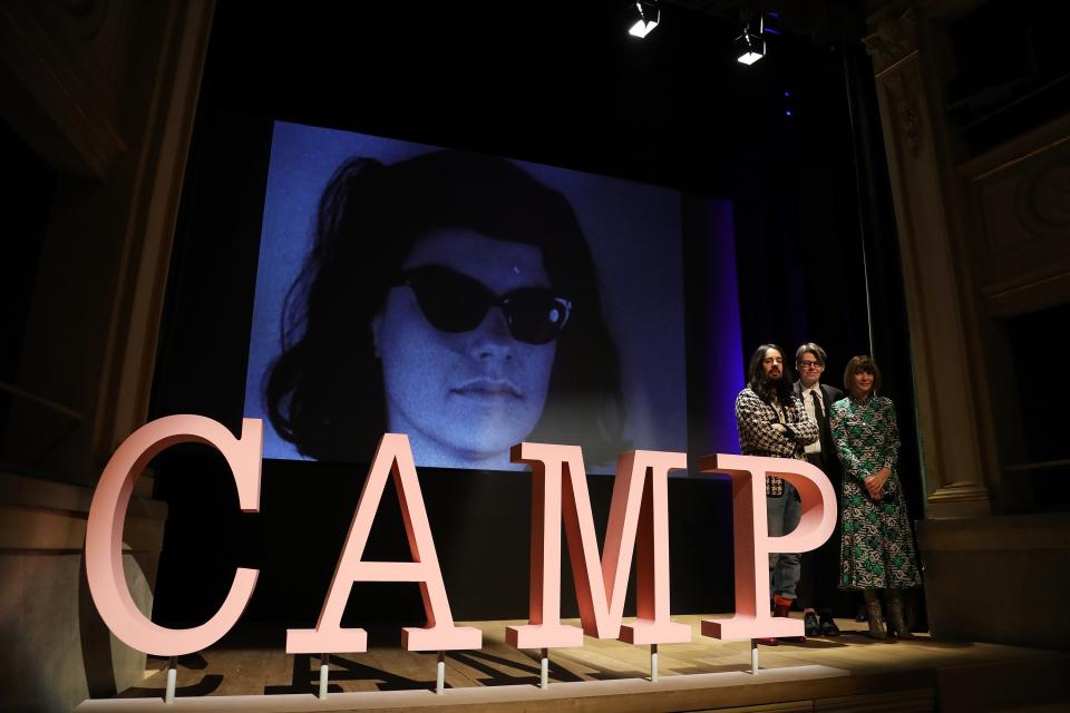 (From left) Alessandro Michele, Andrew Bolton, and Anna Wintour at the Met’s “Camp: Notes on Fashion” advance press event where Andy Warhol’s screen test of Susan Sontag served as a backdrop. Andy Warhol, Screen Test: Susan Sontag [ST319], 1964; Collection of the Andy Warhol Museum, Pittsburgh.