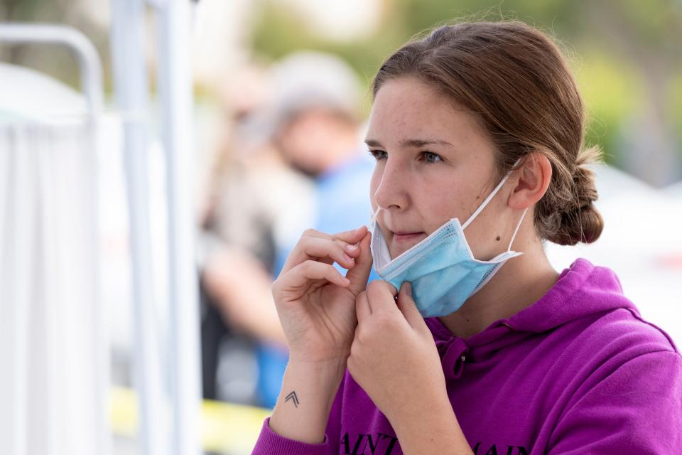 Student Nikola Hudson uses a swab for a COVID-19 test  Wednesday, November 18, 2020. Tulare County Health Department offered a free flu vaccination and COVID-19 testing clinic in the John Muir parking lot of College of the Sequoias.