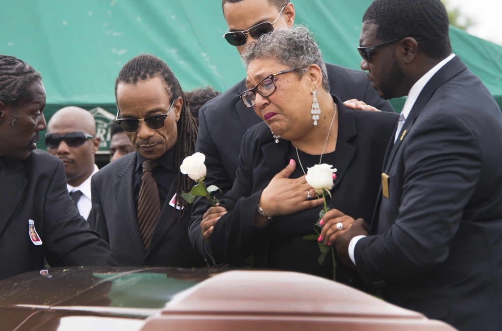 Sharon Risher and son Gary L Washington say their goodbyes to Ethel Lance during her burial at the Emanuel AME Church Cemetery in Charleston, South Carolina, on 25 June, 2015 (AFP via Getty Images)