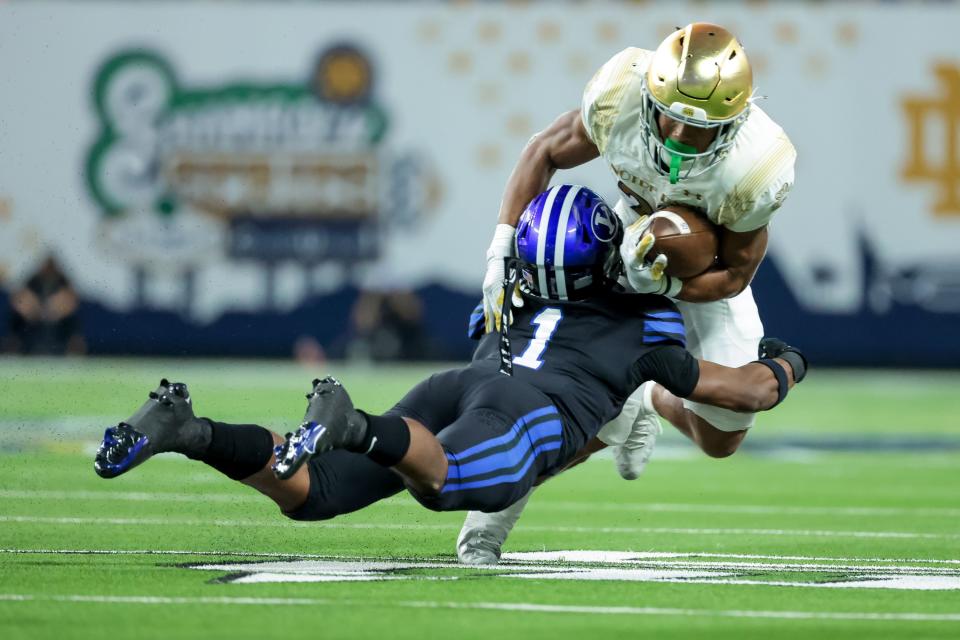 BYU defensive back Micah Harper tackles Notre Dame running back Chris Tyree during the game in Las Vegas on Oct. 8, 2022.