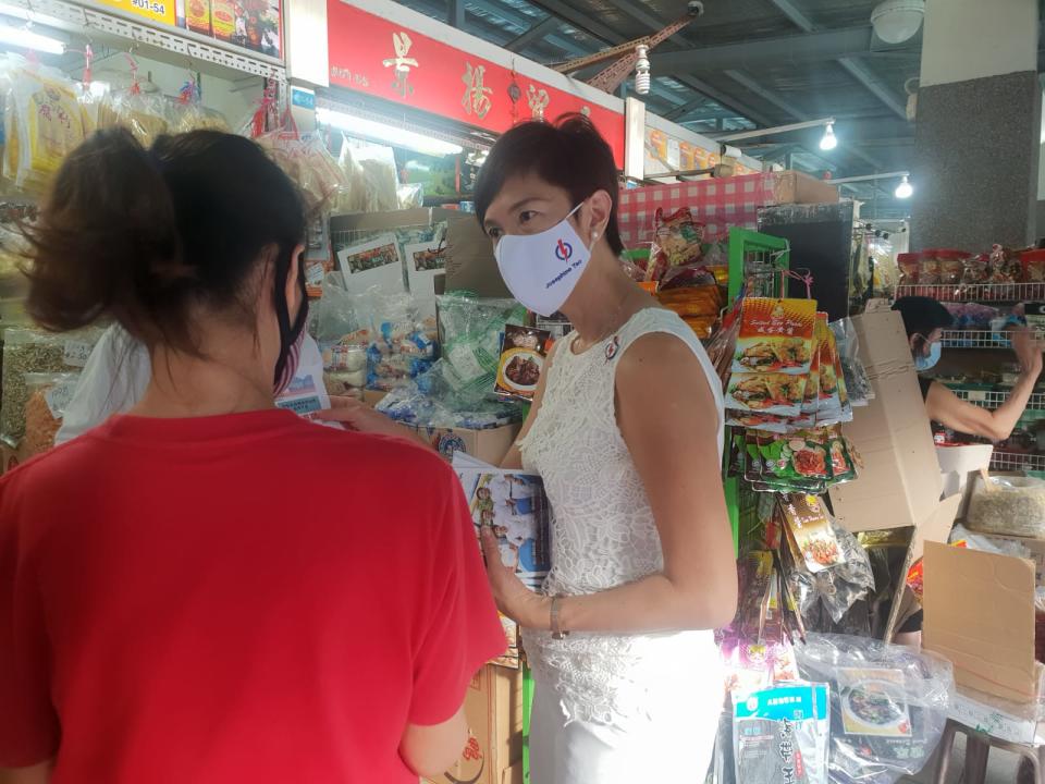 Manpower Minister and PAP candidate for Jalan Besar GRC Josephine Teo (right) on a walkabout at Blk 92 Whampoa Makan Place. (Photo: Wan Ting Koh)