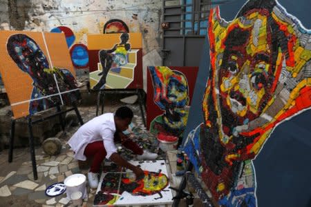 Desire Koffi, 24-year-old artist, works at his workshop in Abidjan, Ivory Coast December 3, 2018. Picture taken December 3, 2018. REUTERS/Luc Gnago