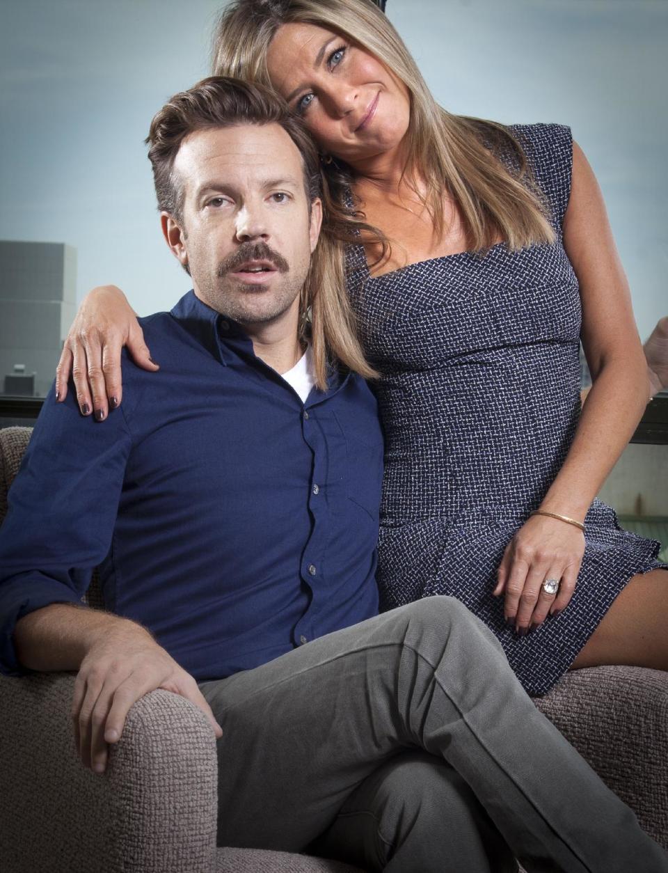 FILE - In this July 27, 2013 file photo, actor Jason Sudeikis, left, and actress Jennifer Aniston pose for a portrait as they promote the movie "We're the Millers" in New York. The film opens nationwide on Wednesday, Aug. 7. (Photo by Carlo Allegri/Invision/AP, File)