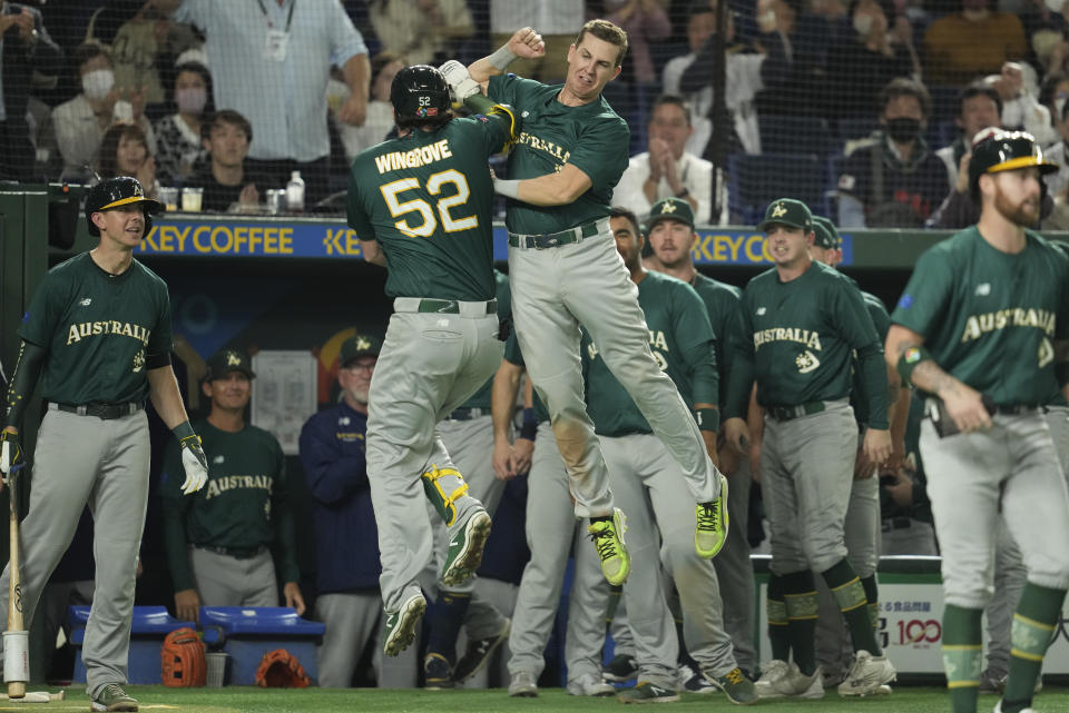 Rixon Wingrove, left, of Australia celebrates with a teammate Robert Glendinning of as he makes a home run during the World Baseball Classic quarterfinal game between Cuba and Australia at the Tokyo Dome Tokyo, Wednesday, March 15, 2023. (AP Photo/Toru Hanai)