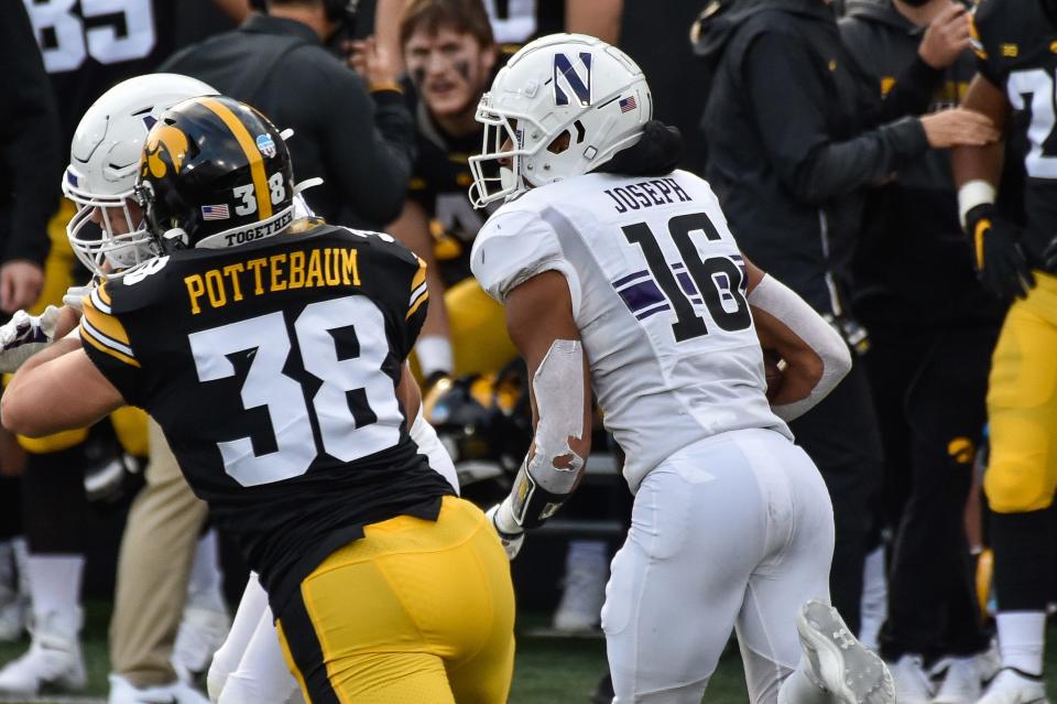 Northwestern defensive back Brandon Joseph (16) returns an interception thrown by Iowa quarterback Spencer Petras (not pictured) at Kinnick Stadium.