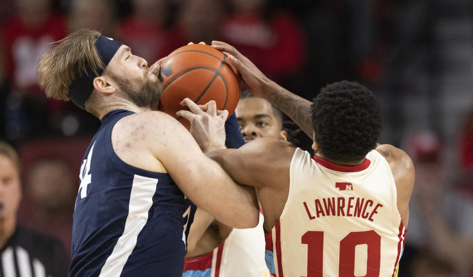 Penn State's Michael Henn, left, battles for possession against Nebraska's Jamarques Lawrence during the first half of an NCAA college basketball game, Sunday, Feb. 5, 2023, in Lincoln, Neb. (AP Photo/Rebecca S. Gratz)