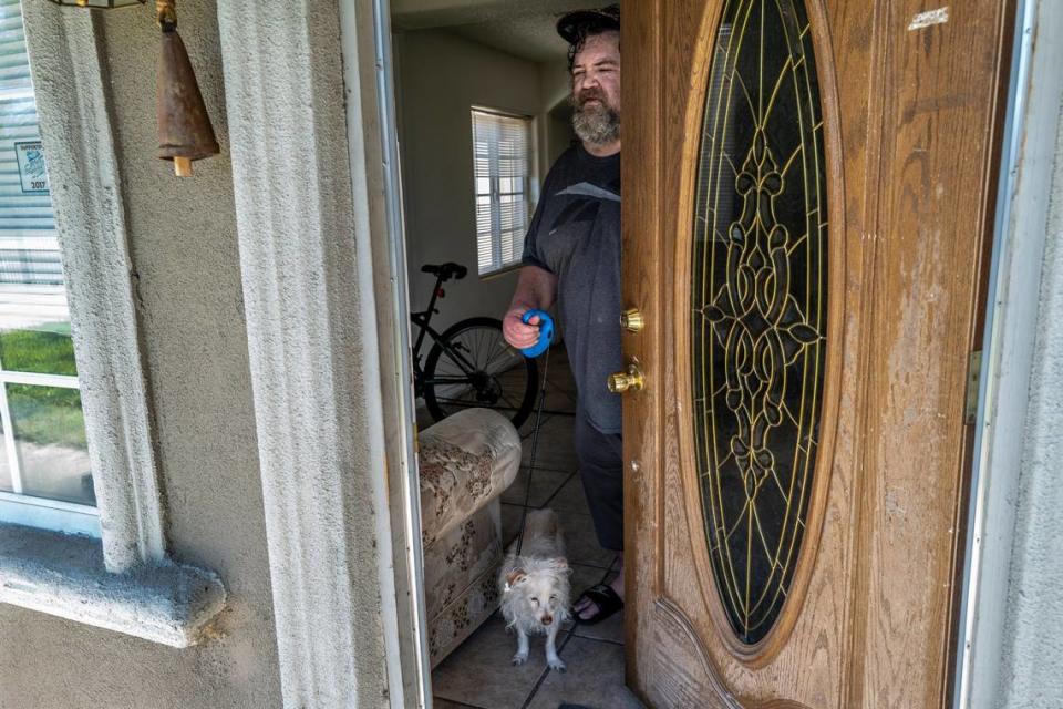 Kevin Haley, who suffers COPD and heart disease stood in the doorway with his dog Danger on Friday. He just moved into the Sacramento Self Help Housing house on Tenaya Street in North Sacramento on Tuesday. “I’m grateful for everything they have done so far and I hope it stays,” said Haley who had no idea where he would go if Sacramento Self Help Housing closed.