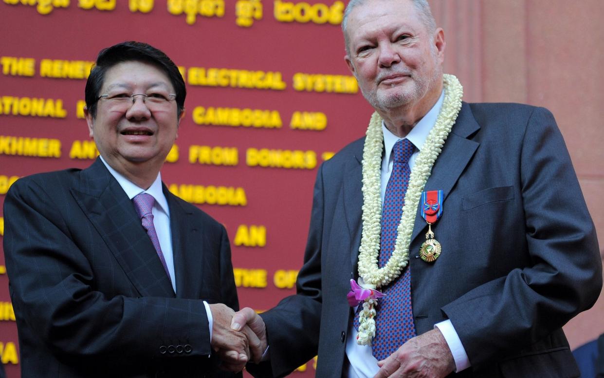 Douglas Latchford, pictured with then Cambodian deputy prime minister Sok An, was once a revered figure in the antiquities world - Tang Chhin Sothy/AFP