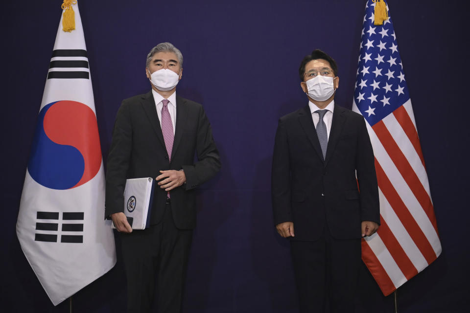 U.S. special representative for North Korea Sung Kim, left, and South Korea's Special Representative for Korean Peninsula Peace and Security Affairs Noh Kyu-duk pose for a photo during their bilateral meeting at a hotel in Seoul Monday, June 21, 2021. (Jung Yeon-je/Pool Photo via AP)