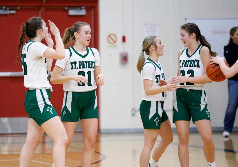 Portland St. Patrick players, including Mattie Honsowitz, from left, Graclyn Rockey, Addison Scheurer and Rylee Schuerer celebrate after defeating Fowler, Friday, Feb. 2, 2024, in Portland.