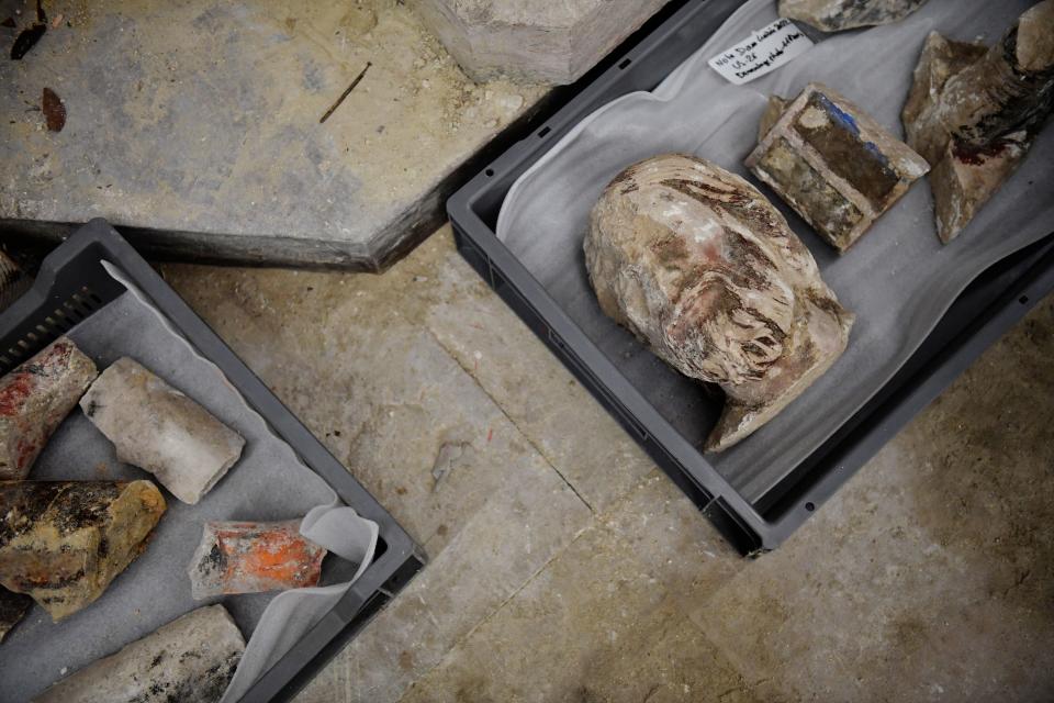 A photo shows antique objects found by archaeologists in the floor of Notre Dame Cathedral after the discovery of a 14th century lead sarcophagus, in Paris, on March 15, 2022. / AFP / JULIEN DE ROSA