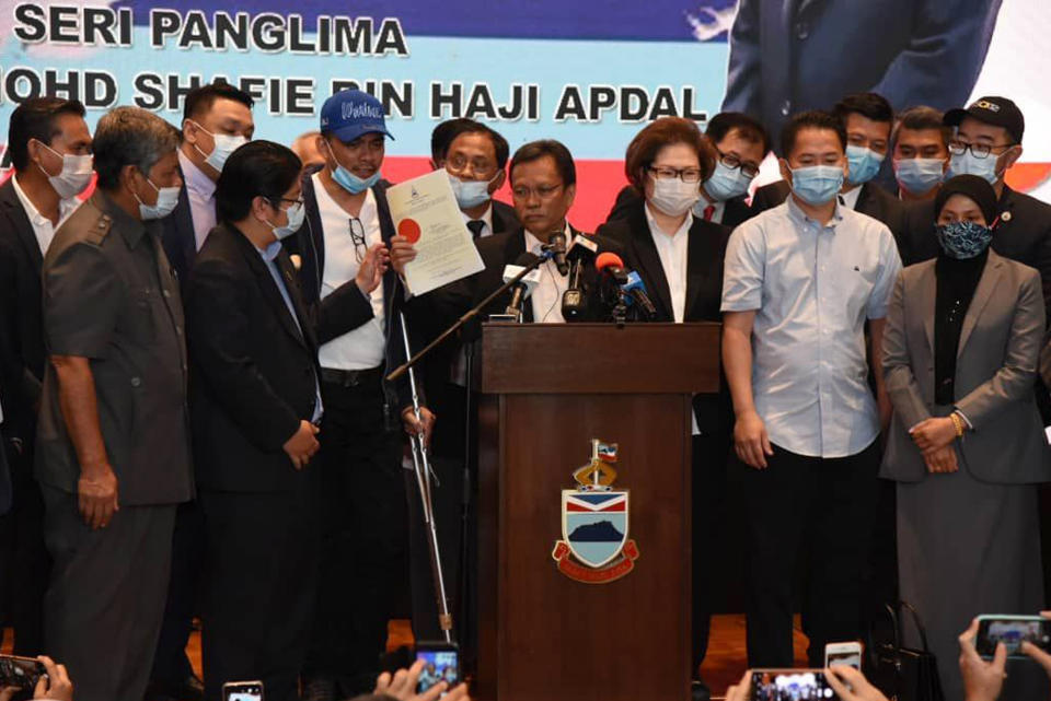 Sabah Chief Minister Shafie Apdal, centre, in Kota Kinabalu, Sabah, Malaysia Thursday, July 30, 2020. Shafie dissolved the state parliament to pave the way for polls after a ruling party politician claimed he had majority support of lawmakers to form a new government. (AP Photo)